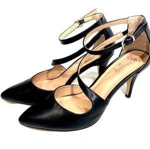 Black faux leather heels with ankle strap.